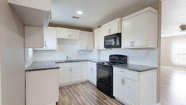 kitchen with white cabinetry, ceiling fan, black appliances, and light wood-type flooring