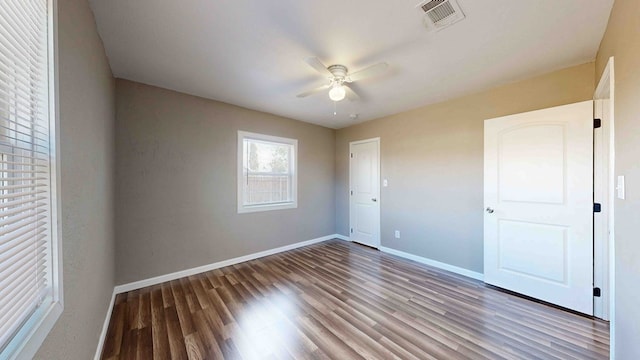 unfurnished bedroom featuring hardwood / wood-style flooring and ceiling fan