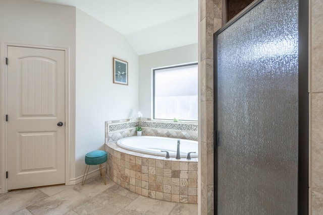 5607 Camino Reale, Midland, TX 79707 - full bath with a garden tub, lofted ceiling, stone tile floors, and a stall shower
