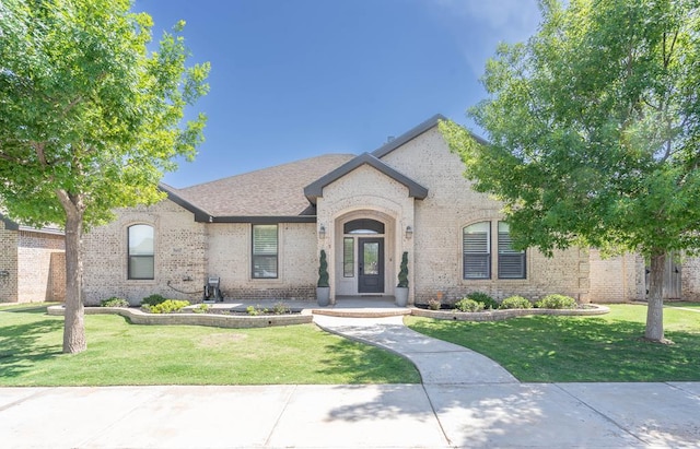 5607 Camino Reale, Midland, TX 79707 - french country inspired facade with brick siding and a front yard