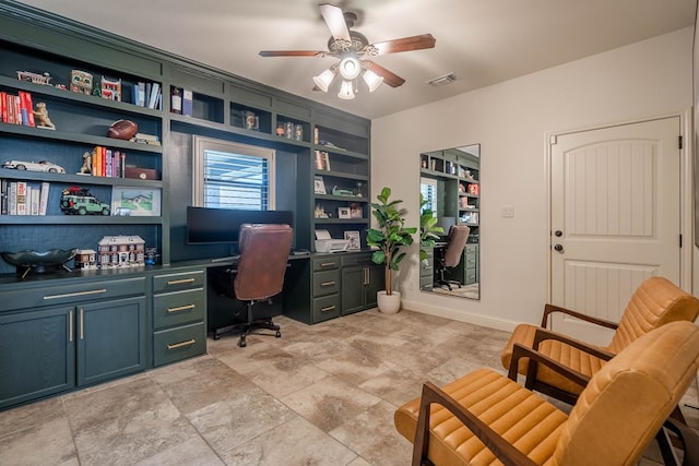 5607 Camino Reale, Midland, TX 79707 - home office with built in desk, a ceiling fan, light stone finish floors, and baseboards