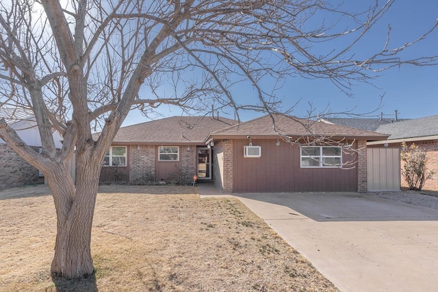 ranch-style house with brick siding and concrete driveway