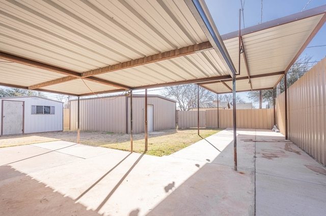 view of patio / terrace with an outdoor structure, a storage shed, and a fenced backyard