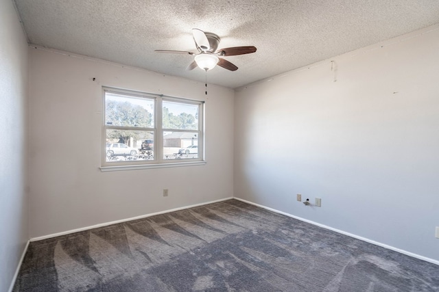 carpeted spare room with a textured ceiling and baseboards