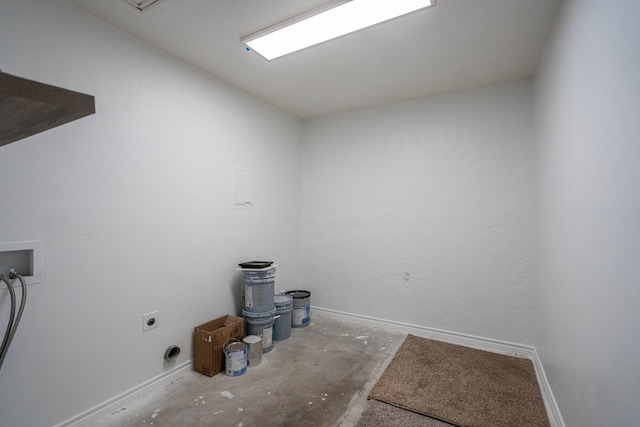 clothes washing area featuring laundry area, electric dryer hookup, and baseboards