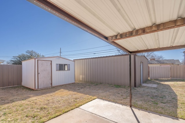 view of patio / terrace with an outdoor structure, a storage shed, and a fenced backyard