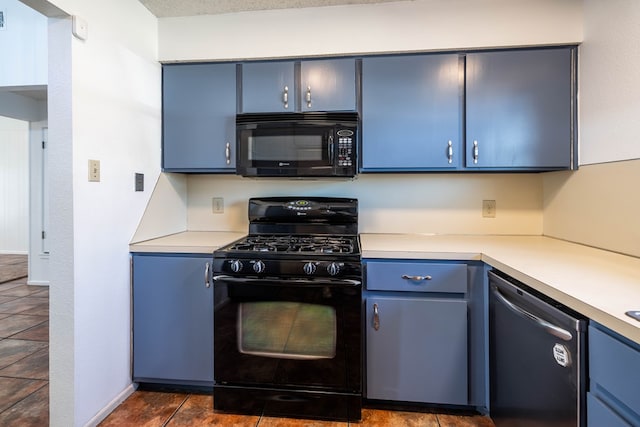 kitchen featuring black appliances, blue cabinetry, and light countertops