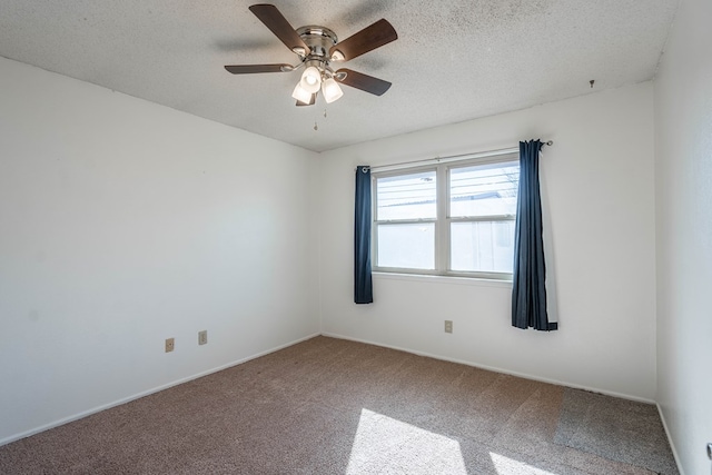 carpeted spare room with a textured ceiling and a ceiling fan