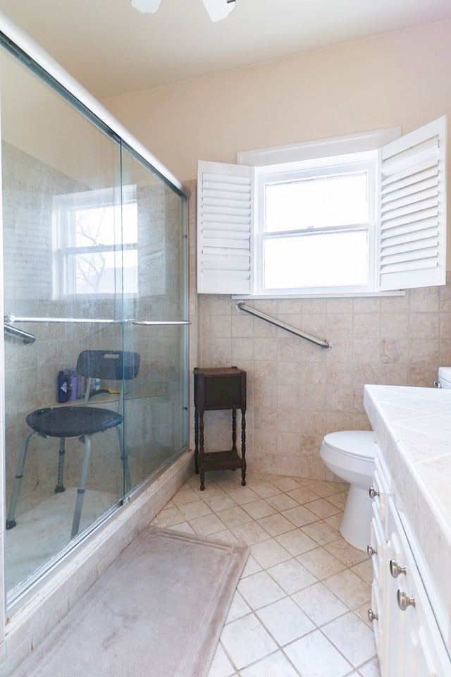 bathroom with vanity, tile patterned floors, toilet, and walk in shower