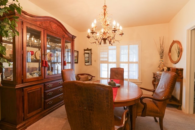 carpeted dining room featuring an inviting chandelier