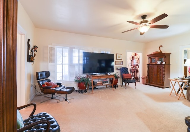 living room with ceiling fan and carpet