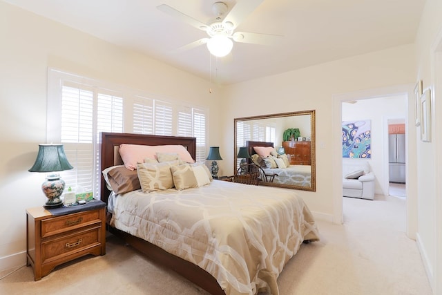 bedroom with light colored carpet and ceiling fan