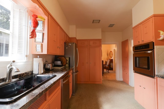 kitchen featuring appliances with stainless steel finishes, sink, and decorative backsplash