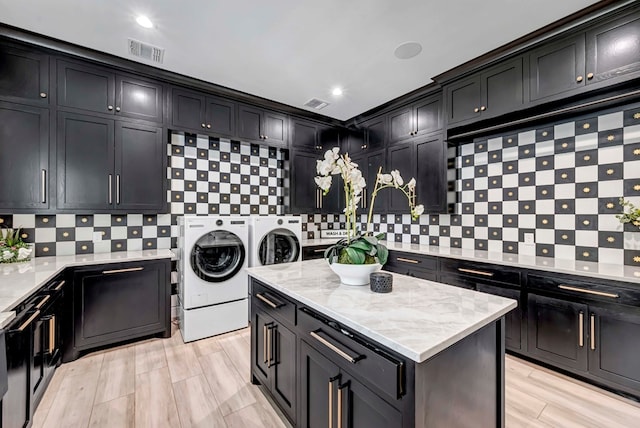 clothes washing area featuring visible vents and washer and dryer