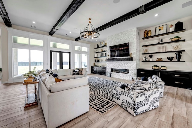 living area featuring plenty of natural light, light wood-style flooring, and beam ceiling