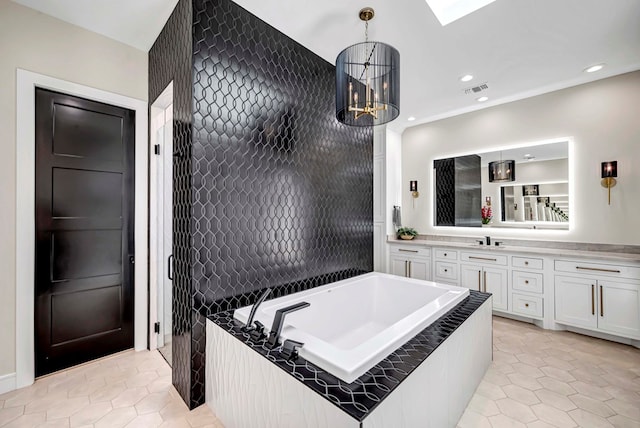 bathroom featuring a bath, vanity, tile patterned flooring, visible vents, and recessed lighting