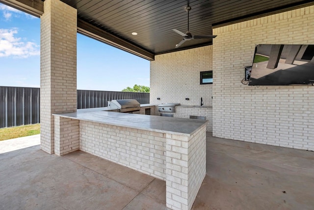 view of patio featuring a grill, a ceiling fan, area for grilling, and outdoor wet bar