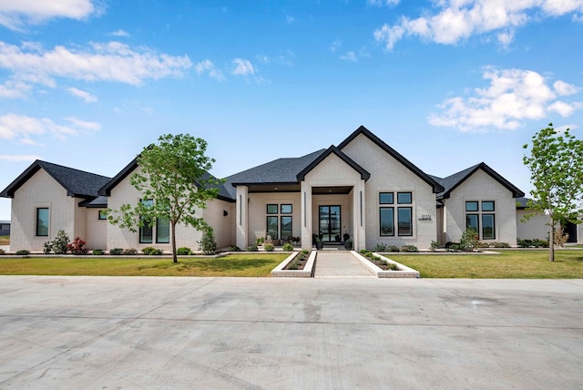 modern farmhouse style home featuring brick siding and a front lawn