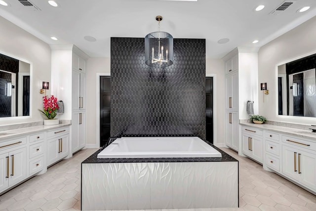 kitchen featuring white cabinets, visible vents, and light tile patterned flooring