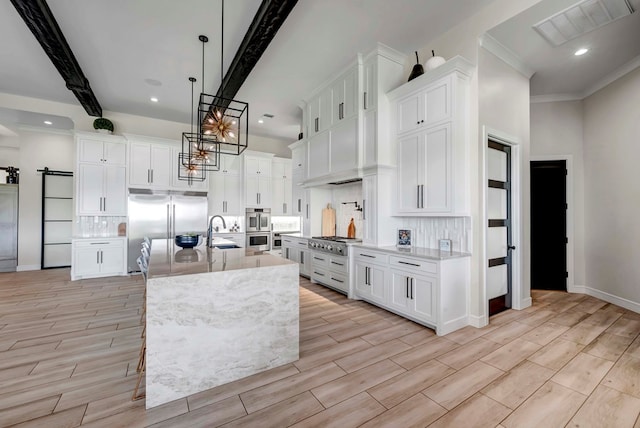 kitchen featuring white cabinets, light wood-style floors, and visible vents