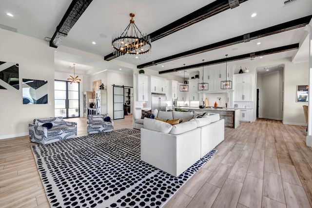 living area with a chandelier, light wood-style flooring, beam ceiling, and baseboards