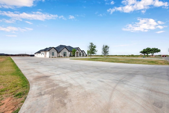 view of road featuring concrete driveway