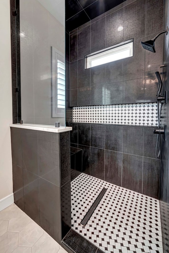 full bathroom featuring tile patterned floors and a walk in shower
