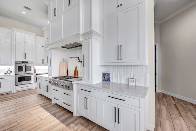 kitchen featuring light wood finished floors, visible vents, white cabinetry, and stainless steel appliances