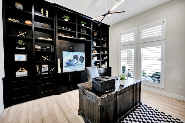 office area with light wood-type flooring and baseboards