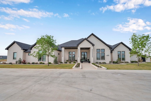 modern farmhouse style home with a front lawn