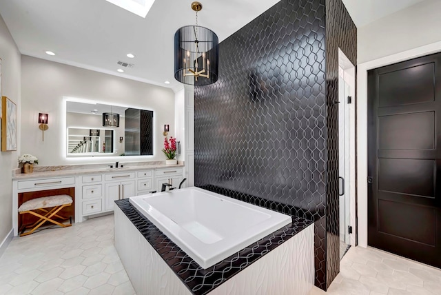 bathroom with tile patterned floors, visible vents, recessed lighting, a garden tub, and vanity