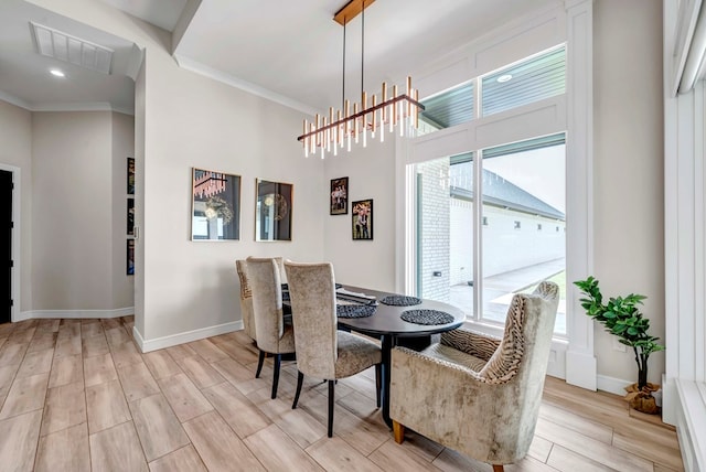 dining area featuring wood tiled floor, visible vents, ornamental molding, baseboards, and a chandelier