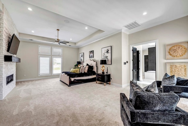 bedroom featuring light carpet, a large fireplace, visible vents, and baseboards