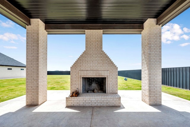 view of patio / terrace featuring an outdoor brick fireplace