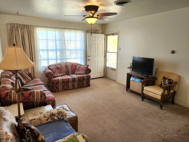 living room with ceiling fan and light carpet