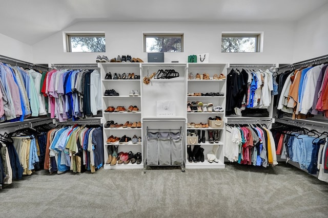 walk in closet with carpet floors and vaulted ceiling