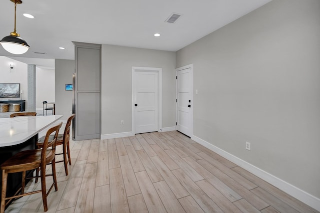 dining space with recessed lighting, baseboards, visible vents, and light wood finished floors