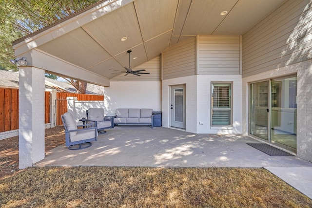 view of patio featuring fence and ceiling fan