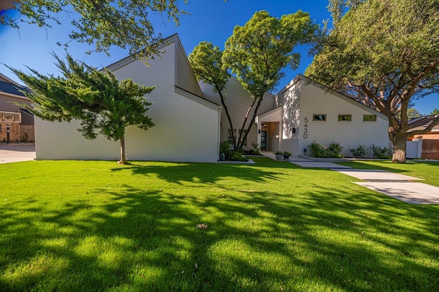 view of front of house with a front lawn and stucco siding