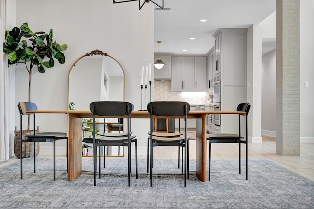 dining area featuring baseboards and recessed lighting