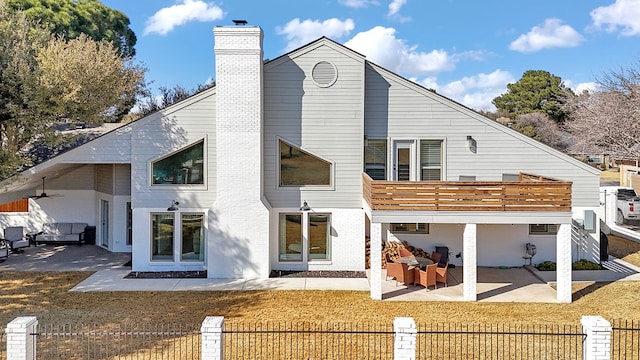 rear view of property with fence private yard, a patio area, a chimney, and a yard