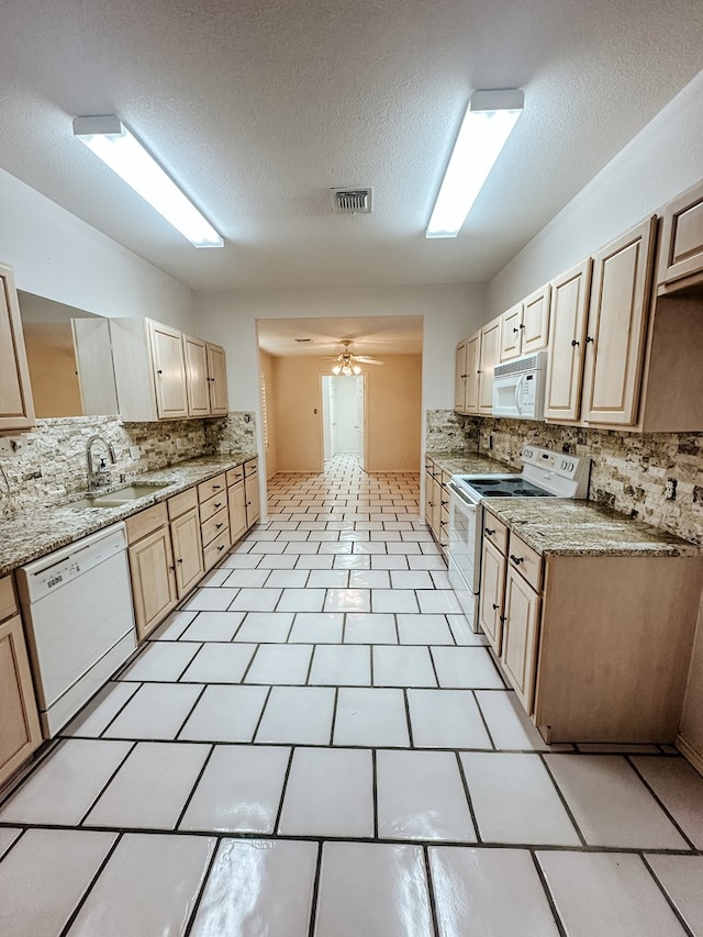 kitchen featuring ceiling fan, sink, light brown cabinetry, and white appliances