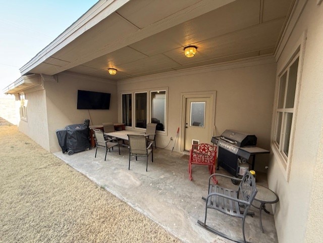 view of patio with outdoor dining area and area for grilling
