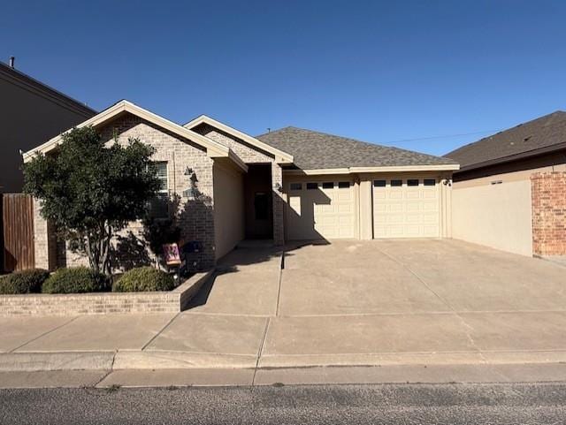 ranch-style house featuring an attached garage, driveway, and brick siding