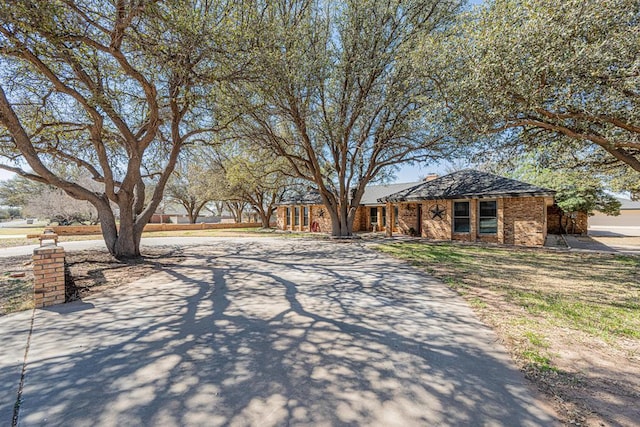 4009 Kniffen Dr, Midland, TX 79705 - view of front of home featuring driveway and brick siding