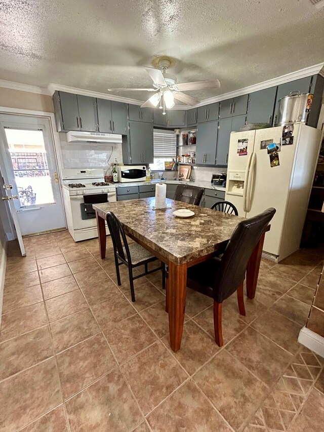 kitchen with a textured ceiling, ceiling fan, white appliances, and ornamental molding