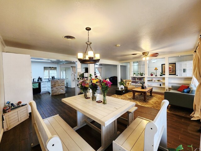 2824 Cimmaron Ave, Midland, TX 79705 - living room with a ceiling fan, dark wood-type flooring, and a chandelier