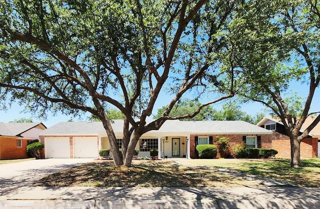 2824 Cimmaron Ave, Midland, TX 79705 - ranch-style house featuring an attached garage, driveway, and brick siding
