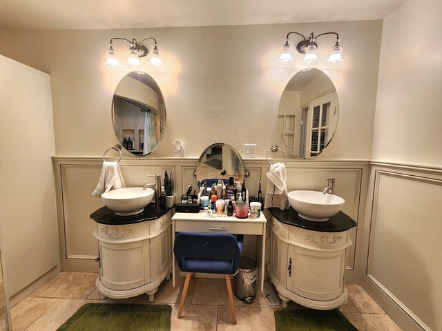 2824 Cimmaron Ave, Midland, TX 79705 - bathroom with a wainscoted wall and two vanities