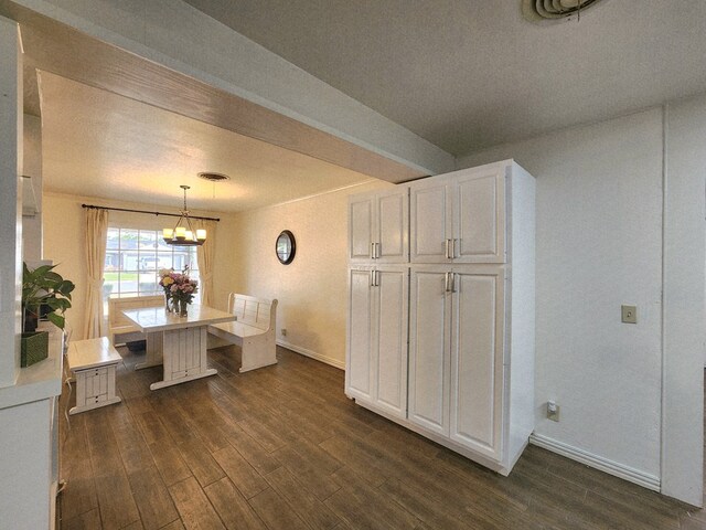 2824 Cimmaron Ave, Midland, TX 79705 - dining room with baseboards, a chandelier, and dark wood-style flooring